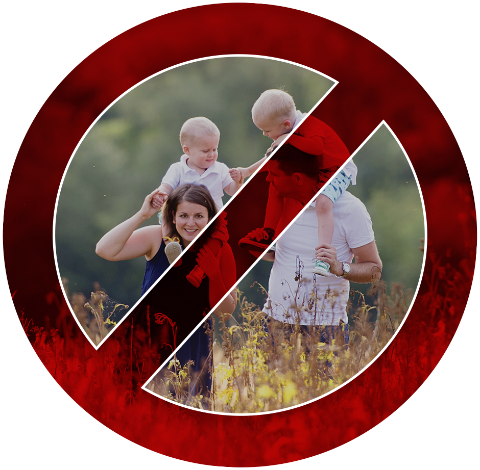 A bold red prohibited symbol crossing out an image of a man and a woman holding children on their shoulders while standing in a field.